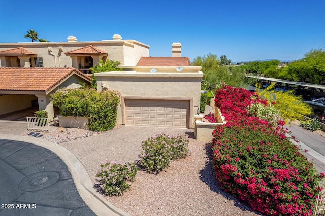 view of front of house with an attached garage, concrete driveway, and stucco siding