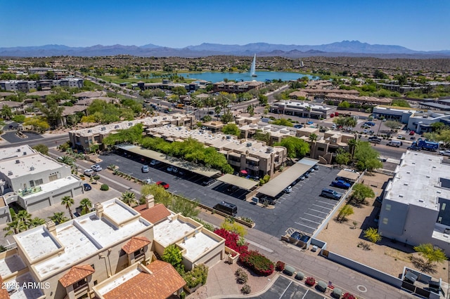 drone / aerial view featuring a water and mountain view