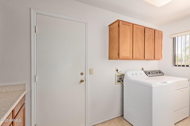 washroom featuring cabinet space and independent washer and dryer