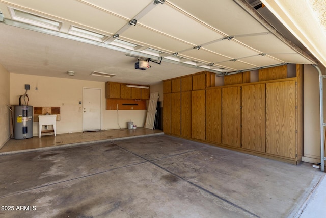 garage with a sink, a garage door opener, and electric water heater