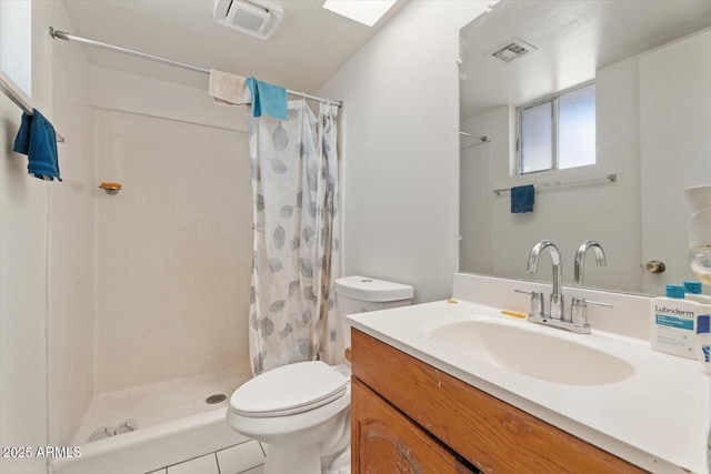 bathroom with tile patterned floors, toilet, vanity, and walk in shower