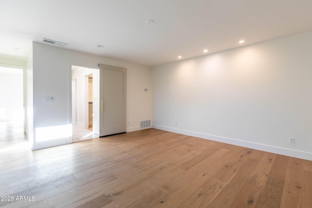 spare room featuring light hardwood / wood-style floors