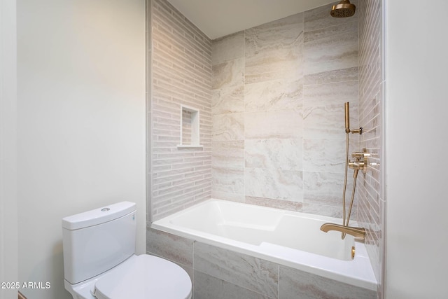 bathroom with toilet and tiled shower / bath combo