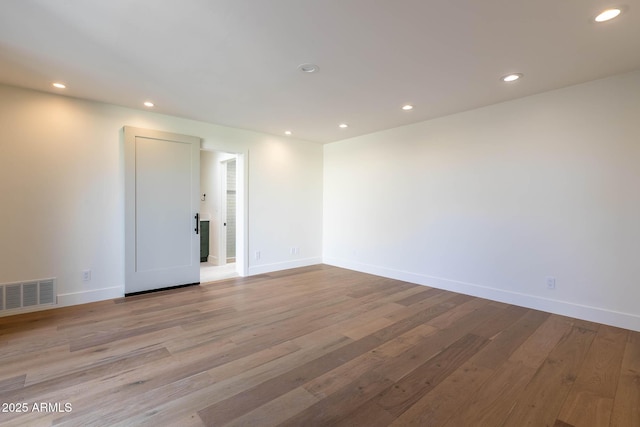 spare room featuring light hardwood / wood-style floors