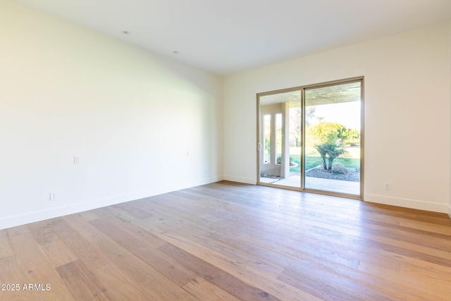 unfurnished room with light hardwood / wood-style flooring