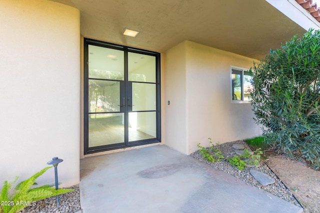 property entrance with french doors and a patio area