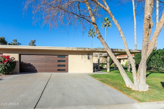 view of front of house with a front yard and a garage