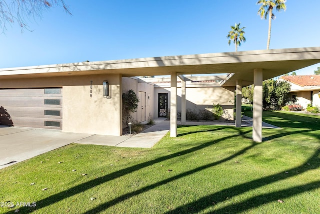 exterior space featuring a garage and a front lawn