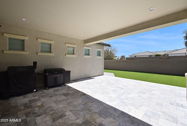 view of patio / terrace featuring fence and grilling area