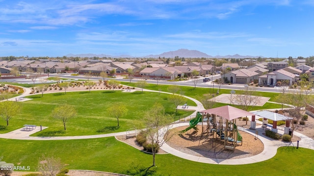 view of community with playground community, a mountain view, and a residential view