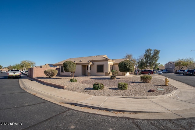 view of front of home with stucco siding and a tiled roof