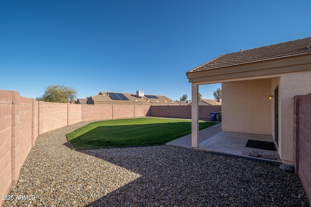 view of yard with a patio area and a fenced backyard