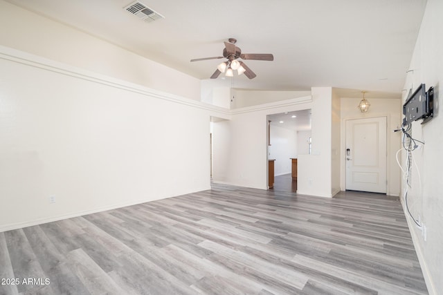 unfurnished living room featuring ceiling fan, lofted ceiling, visible vents, and light wood-type flooring