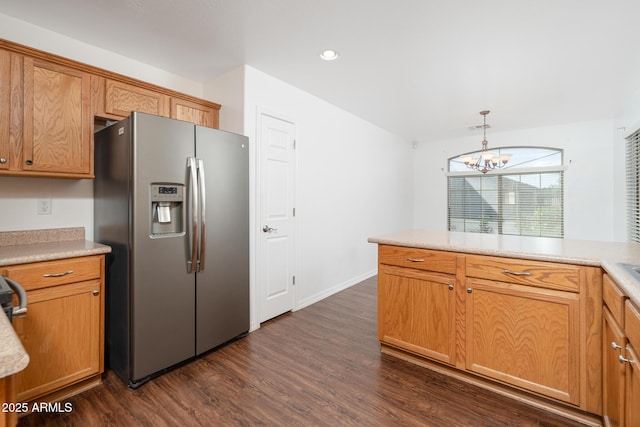 kitchen with stainless steel fridge with ice dispenser, dark wood finished floors, decorative light fixtures, light countertops, and an inviting chandelier