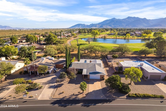 drone / aerial view with a water and mountain view