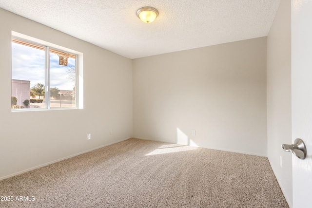 unfurnished room with a textured ceiling and carpet flooring