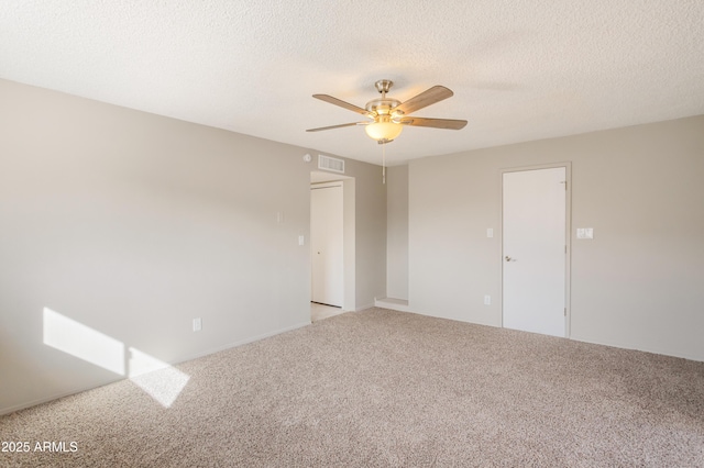 unfurnished room featuring light carpet, a textured ceiling, and ceiling fan