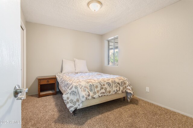 carpeted bedroom featuring a closet and a textured ceiling