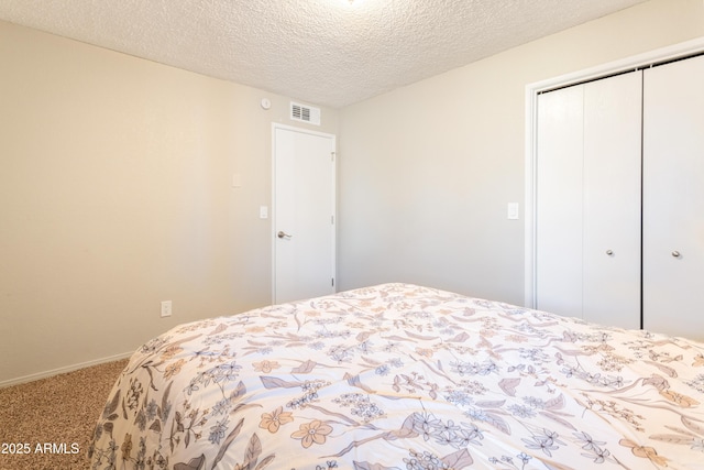 carpeted bedroom featuring a closet and a textured ceiling