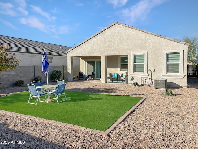 rear view of house featuring a lawn, central air condition unit, and a patio