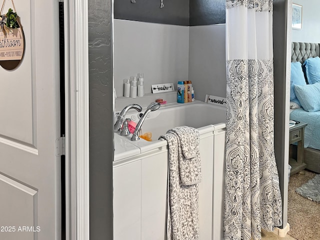 bathroom featuring a tub to relax in