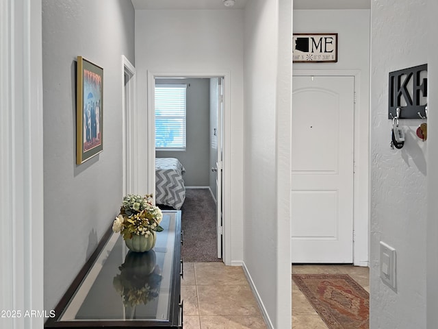 hallway featuring light colored carpet