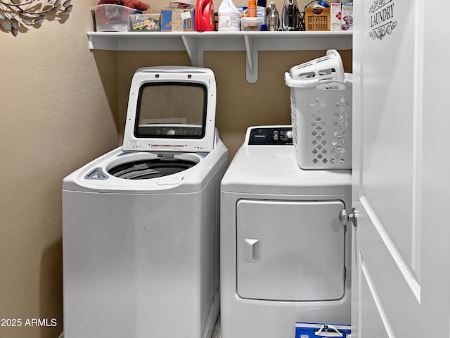 washroom with washing machine and clothes dryer