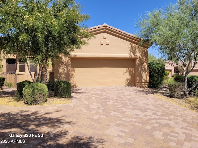 16538 E Westwind Ct Unit 51, Fountain Hills, AZ 85268 - view of front of home with decorative driveway, a garage, stucco siding, and a tile roof