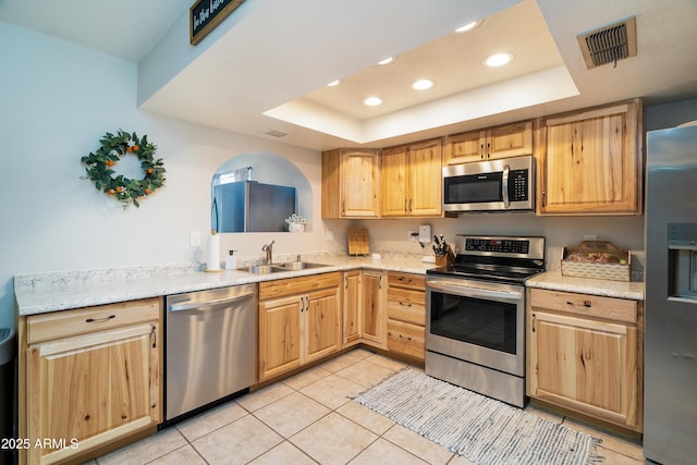 1531 S Padre Rd, Apache Junction, AZ 85119 - kitchen featuring appliances with stainless steel finishes, a sink, a tray ceiling, recessed lighting, and light brown cabinets