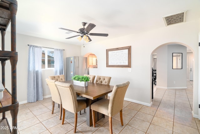 1531 S Padre Rd, Apache Junction, AZ 85119 - dining space with arched walkways, light tile patterned floors, a ceiling fan, and baseboards