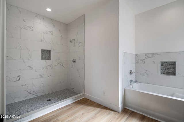 bathroom featuring wood-type flooring and independent shower and bath