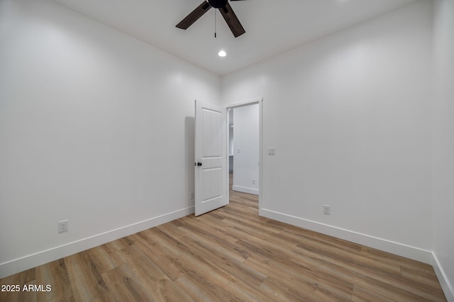 empty room with ceiling fan and light wood-type flooring