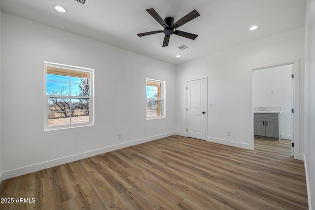 unfurnished bedroom featuring ceiling fan, light hardwood / wood-style floors, and ensuite bath