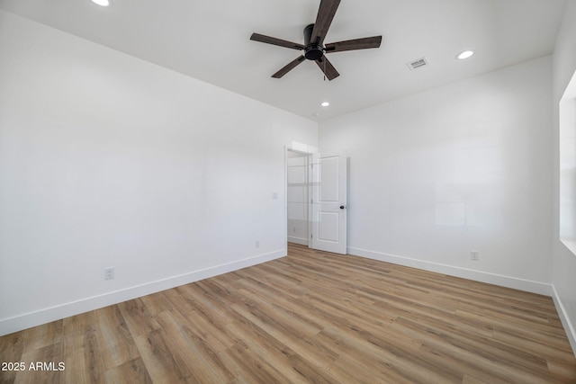 unfurnished room with ceiling fan and light wood-type flooring