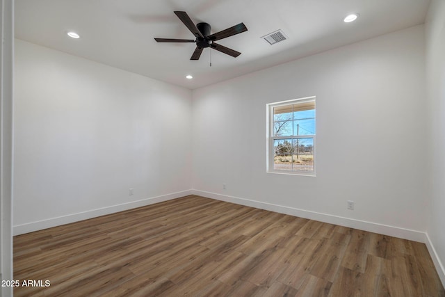 empty room with hardwood / wood-style flooring and ceiling fan