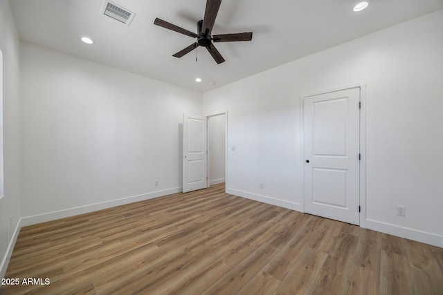 empty room featuring ceiling fan and light wood-type flooring