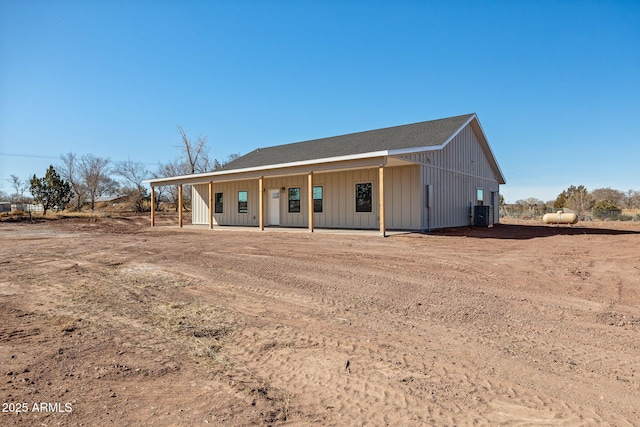 ranch-style home featuring cooling unit and covered porch