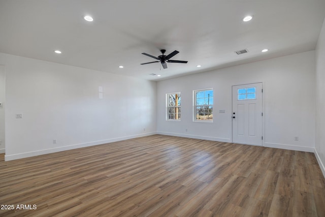 unfurnished living room with ceiling fan and light wood-type flooring