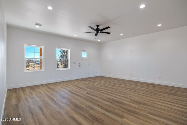 unfurnished living room featuring ceiling fan and light wood-type flooring