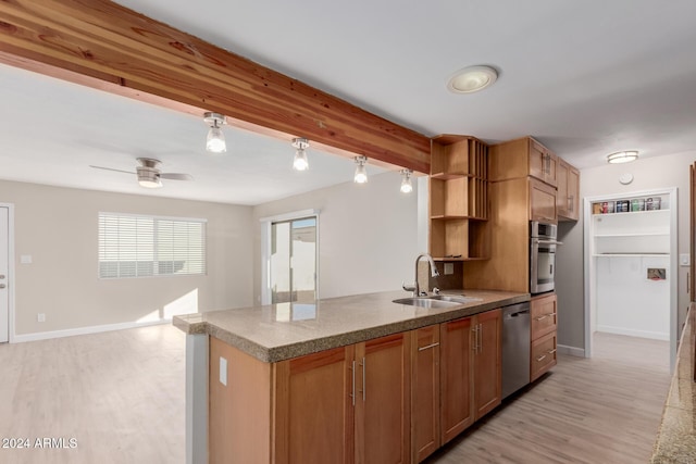 kitchen featuring ceiling fan, sink, stainless steel appliances, and light wood-type flooring