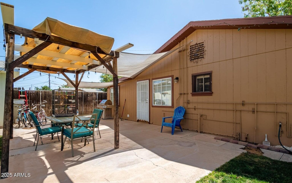view of patio / terrace featuring outdoor dining area, fence, area for grilling, and a pergola