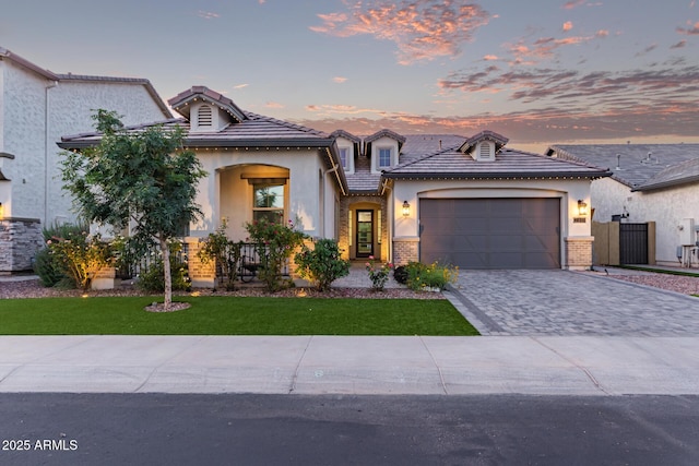 2316 E Canary Dr, Gilbert, AZ 85297 - view of front facade featuring stucco siding, decorative driveway, an attached garage, and a lawn