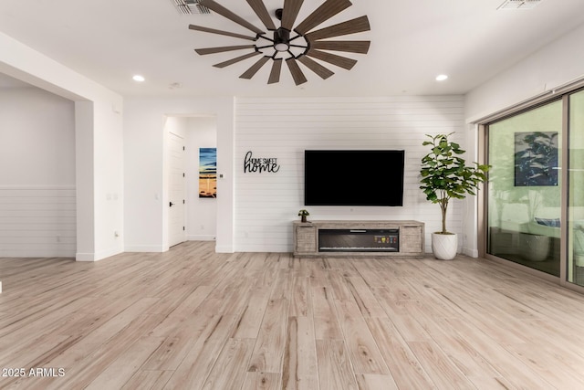 2316 E Canary Dr, Gilbert, AZ 85297 - unfurnished living room with ceiling fan, wood finished floors, recessed lighting, baseboards, and a glass covered fireplace