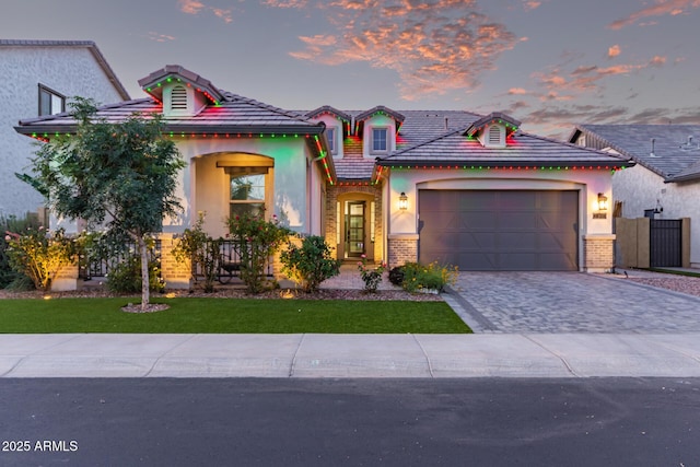 2316 E Canary Dr, Gilbert, AZ 85297 - view of front of home featuring stucco siding, decorative driveway, an attached garage, a yard, and a tile roof