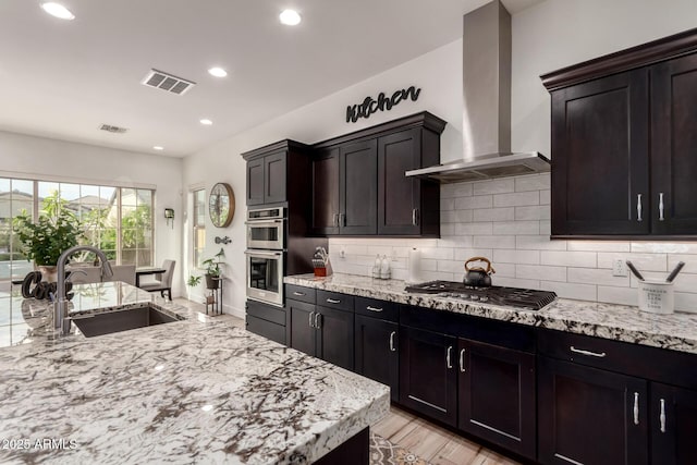 2316 E Canary Dr, Gilbert, AZ 85297 - kitchen with island exhaust hood, a sink, backsplash, light stone countertops, and recessed lighting