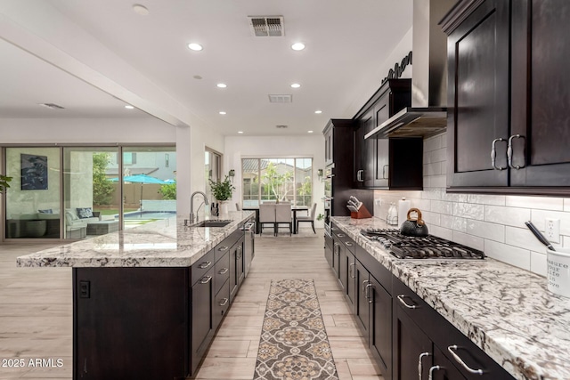 2316 E Canary Dr, Gilbert, AZ 85297 - kitchen featuring a sink, appliances with stainless steel finishes, light stone countertops, light wood-type flooring, and recessed lighting