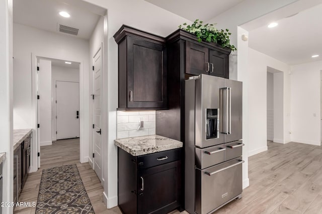 2316 E Canary Dr, Gilbert, AZ 85297 - kitchen featuring high end fridge, light wood-style flooring, baseboards, dark brown cabinetry, and recessed lighting