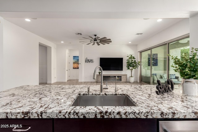 2316 E Canary Dr, Gilbert, AZ 85297 - kitchen featuring a sink, wood finished floors, open floor plan, light stone countertops, and dishwasher