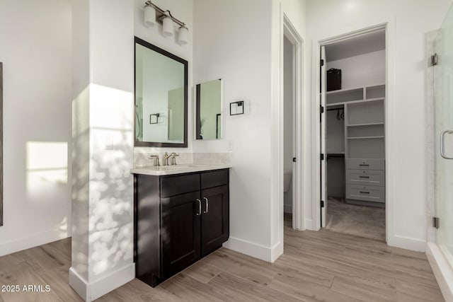2316 E Canary Dr, Gilbert, AZ 85297 - bathroom with a shower stall, vanity, and wood finished floors