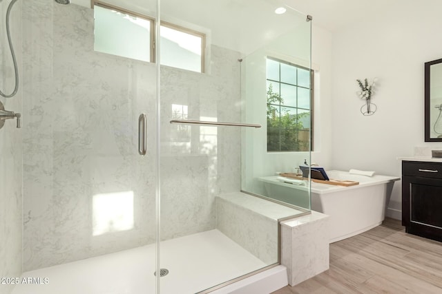2316 E Canary Dr, Gilbert, AZ 85297 - full bath with a marble finish shower, wood finished floors, vanity, and a tub to relax in